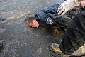 A police officer lying on the ground beaten seen during clashes in Ukraine, Kyiv. Events of February 18, 2014