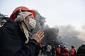 A woman making her prayer right in the middle of raging clashes. Ukraine, Kyiv. Events of February 19, 2014