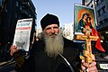 Christian priest expressing his support to activists seen during clashes in Kyiv, Ukraine. Events of February 18, 2014