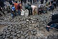 Protesters dismantling brickstone pavement to use it as a mean of self-defence. Clashes in Ukraine, Kyiv. Events of February 19, 2014.