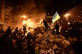 SState flag of Ukraine carried by a protester to the heart of developing clashes in Kyiv, Ukraine. Events of February 18, 2014