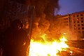 Protester seen against background of the massive fire set by protesters to prevent internal forces from crossing the barricade line. Kyiv, Ukraine. Jan 22, 2014