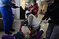 Ukrainian Red Cross volunteers giving first medical aid to a wounded protester in a makeshift hospital in the hotel Ukraine lobby. Clashes in Kyiv, Ukraine. Events of February 20, 2014