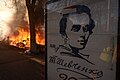 A poster stating congratulations with approaching anniversary of Taras Shevchenko against background of burning barricades. Clashes in Kyiv, Ukraine. Events of February 18, 2014