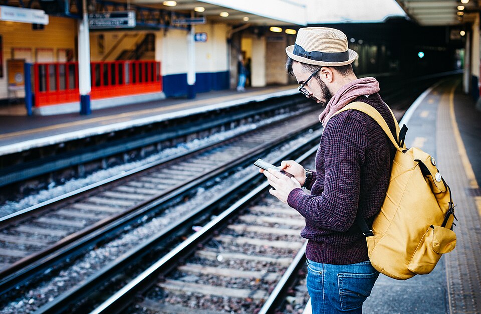File:Backpacker waiting for the train (Unsplash).jpg