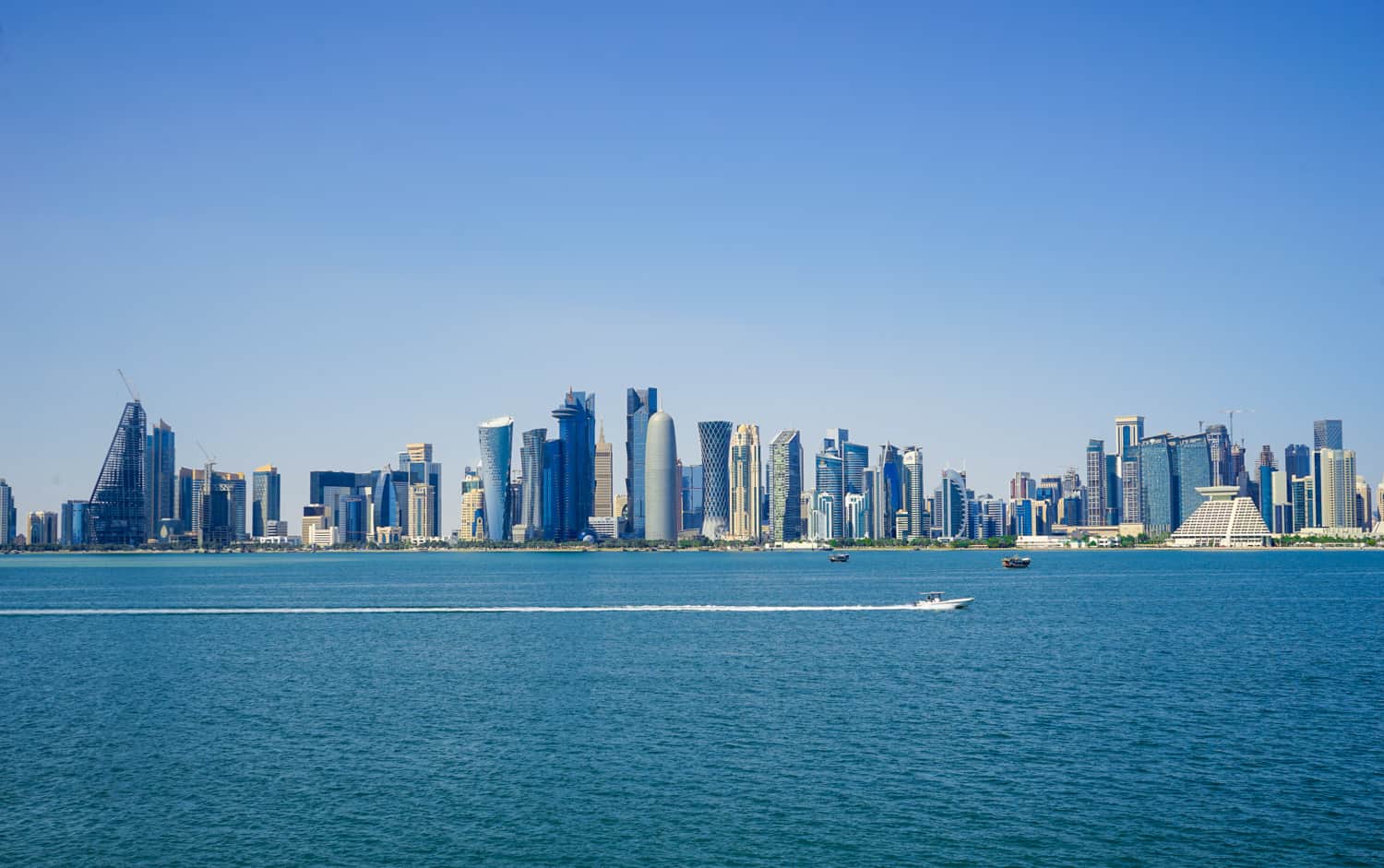 Looking over a large body of water with a modern city skyline in background