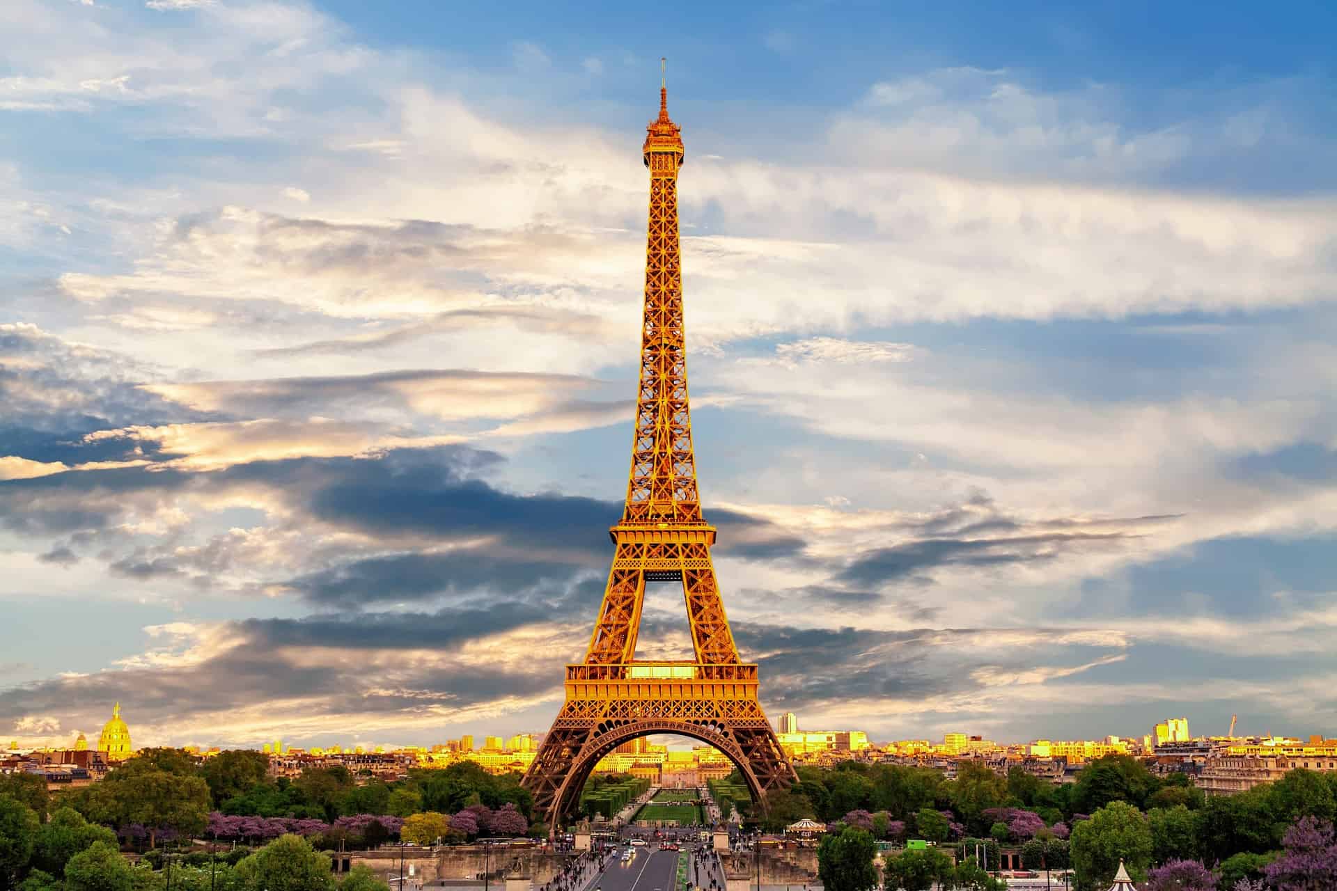 Wide-angle view of the Eiffel Tower with clouds behind