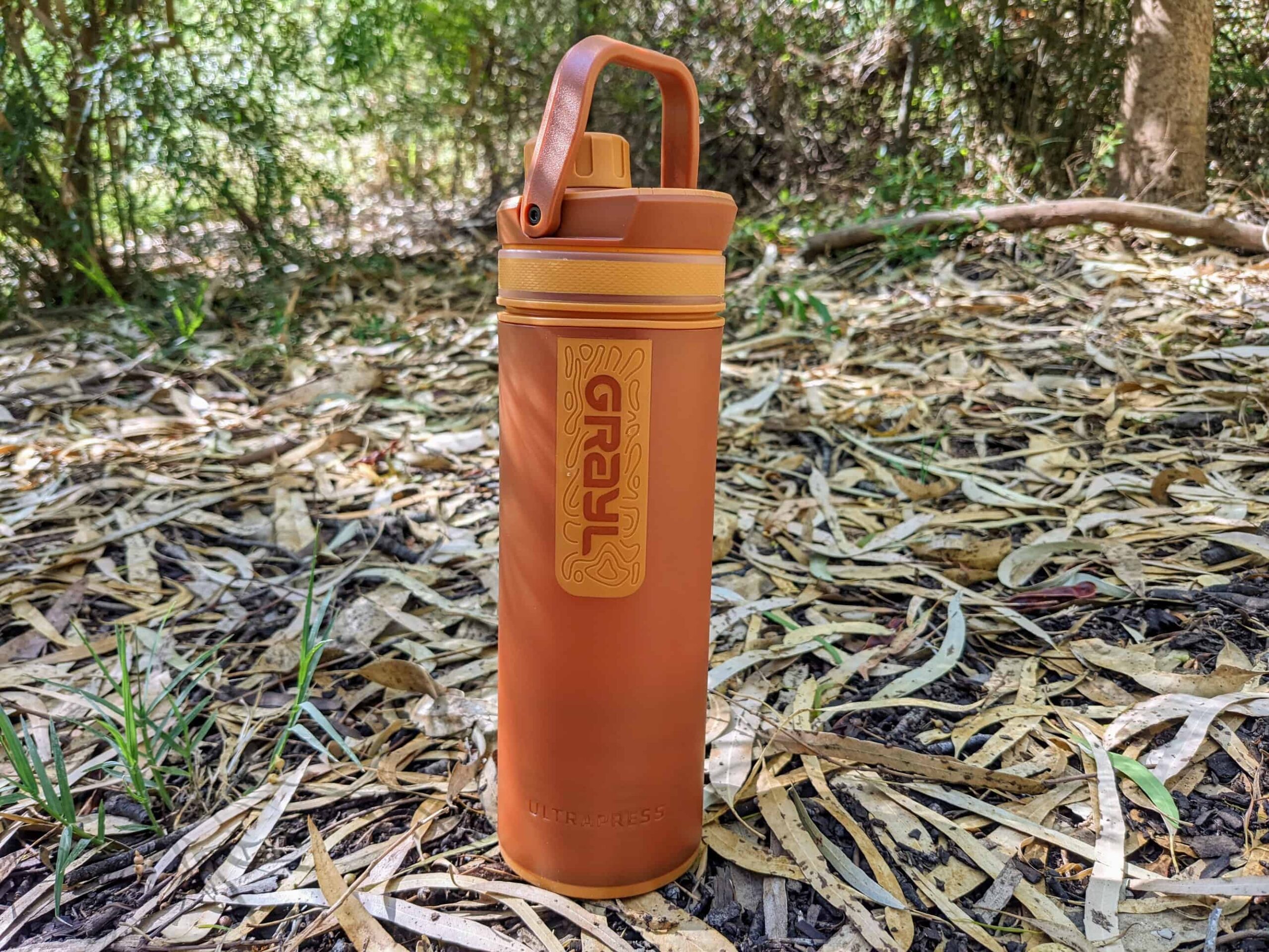 GRAYL UltraPress sitting on a bed of fallen leaves