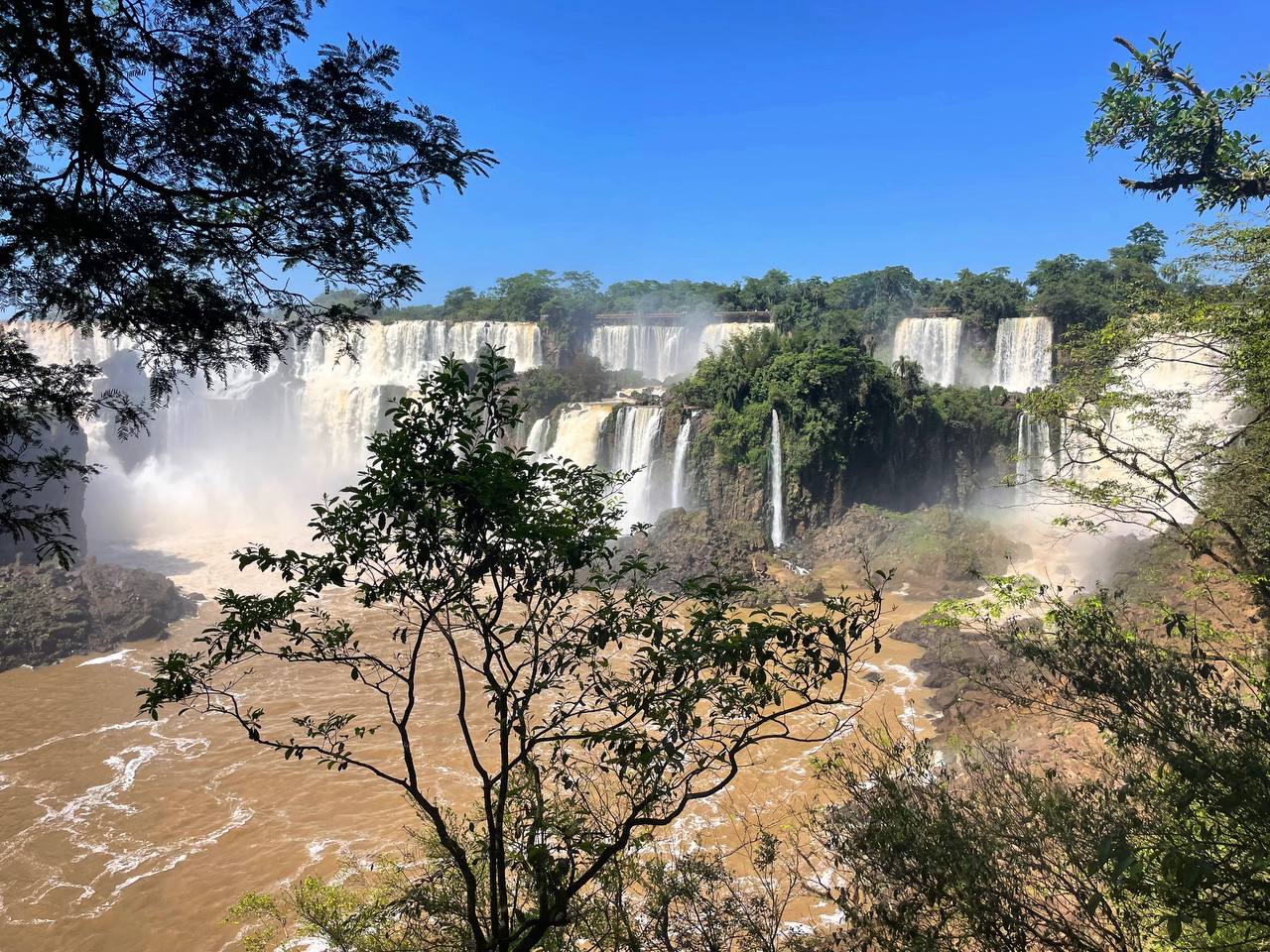 Iguazu Falls from the Argentina side. Several large, impressive waterfalls alongside each other in a jungle setting