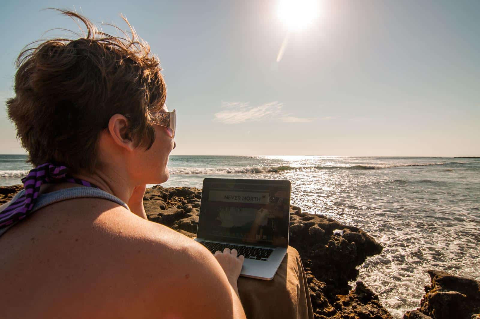 Jenny on laptop on beach