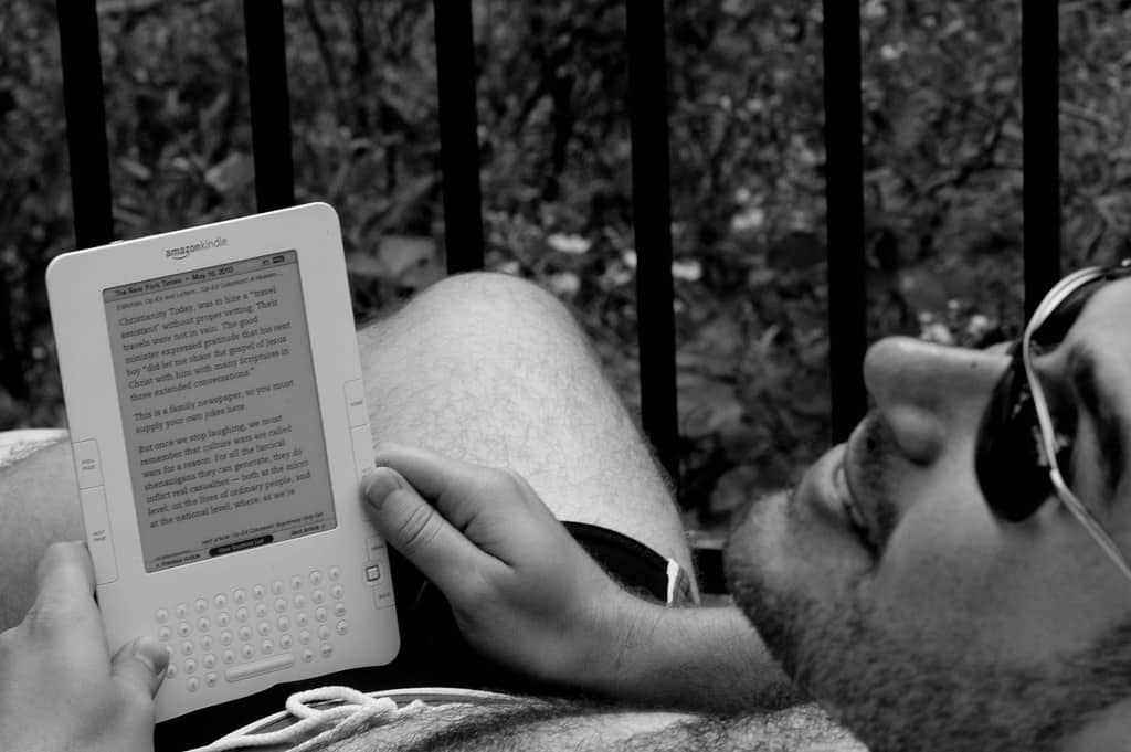 Man reading Kindle Keyboard