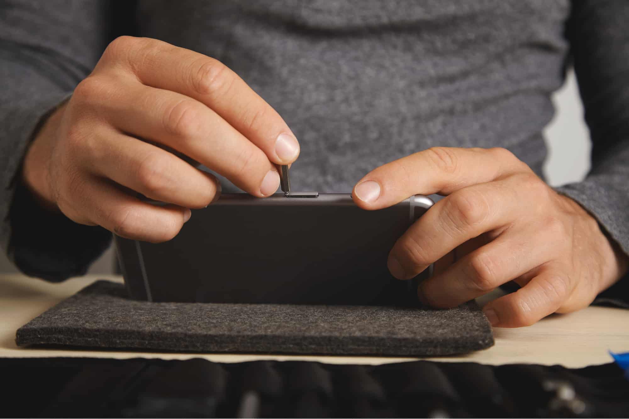 Man removing SIM card from phone