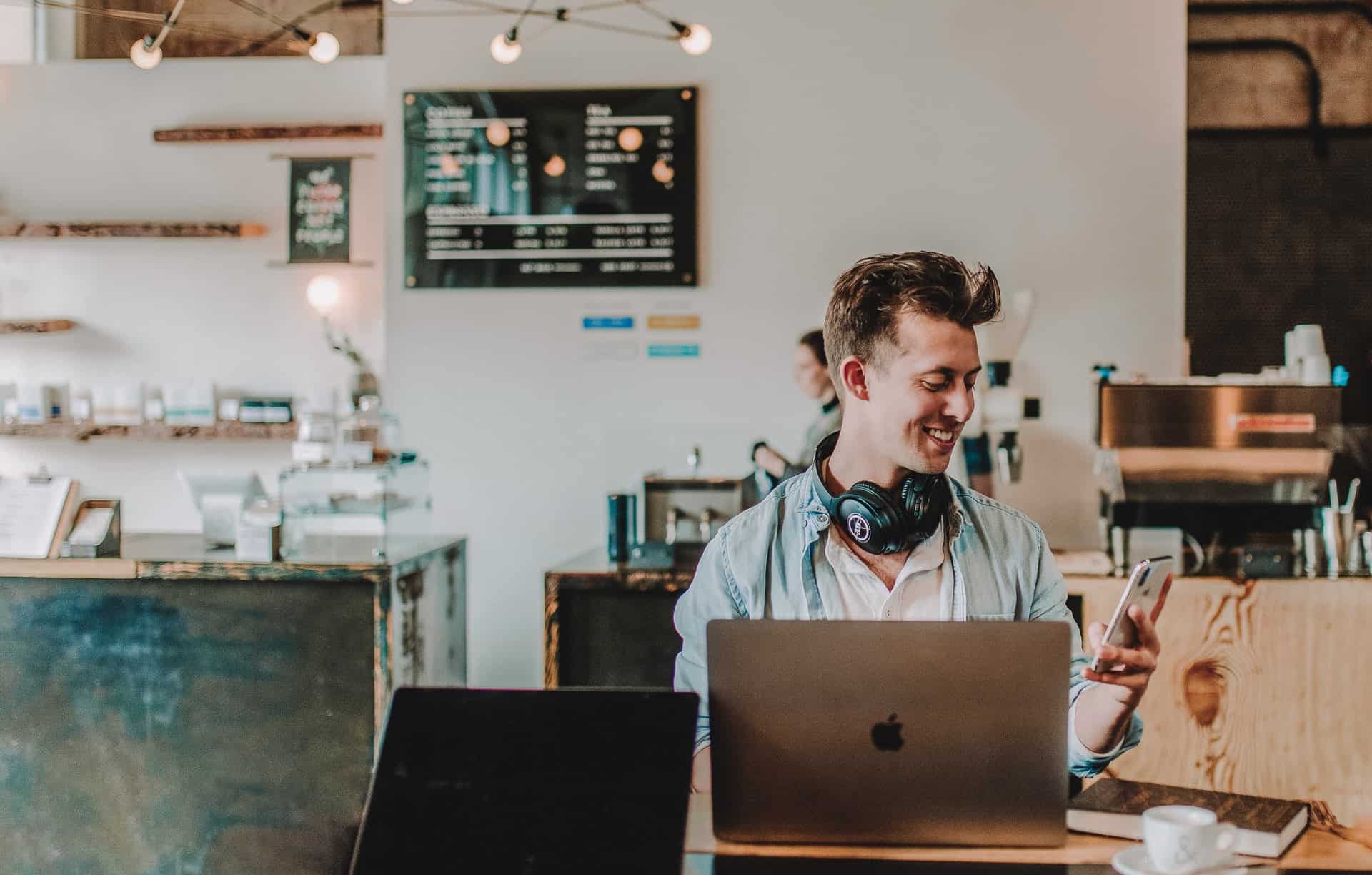 Man working in cafe with laptop