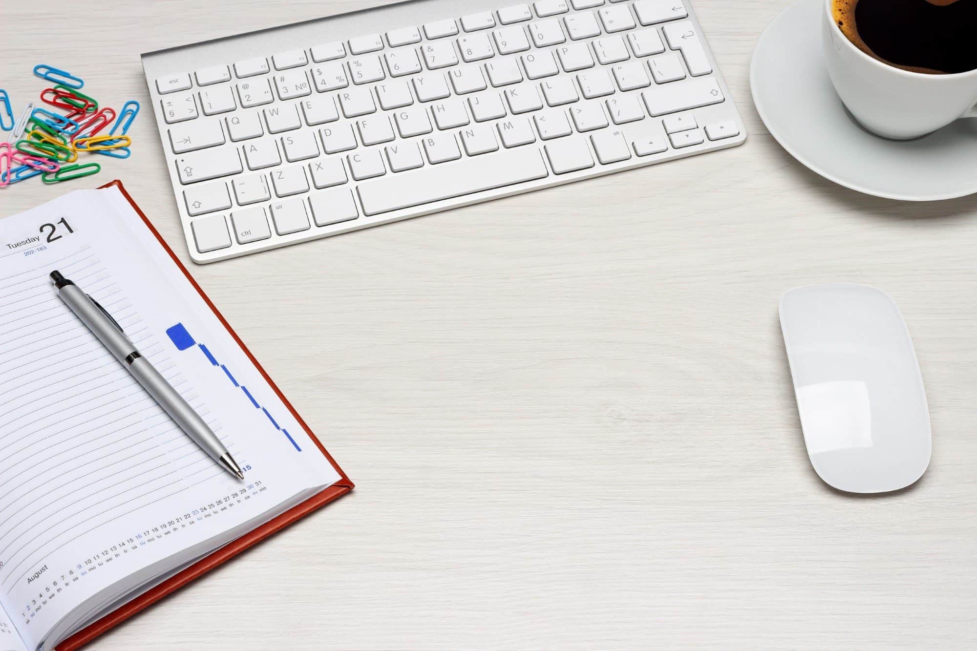 Mouse, keyboard, coffee, notebook