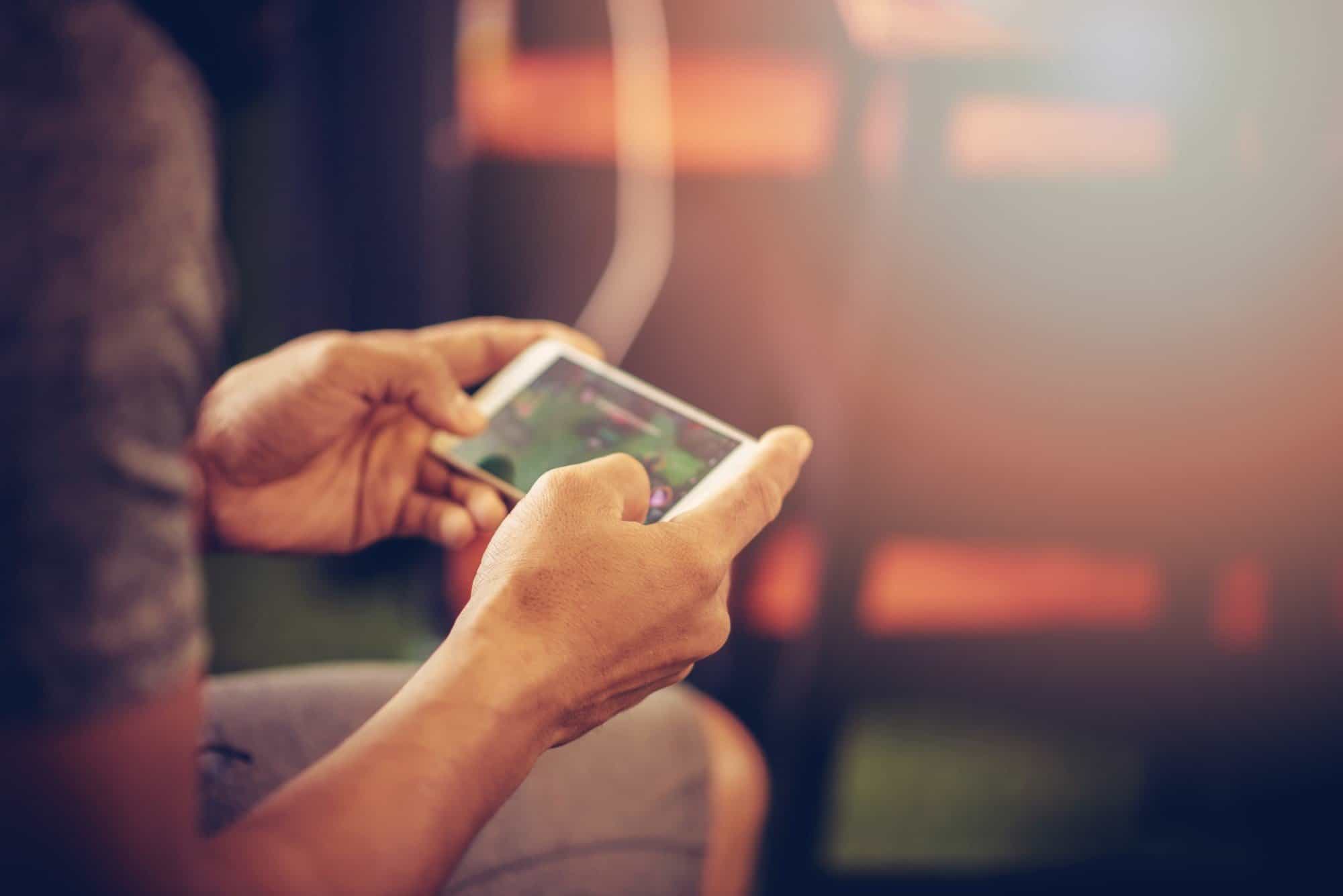 Person playing game on iPhone