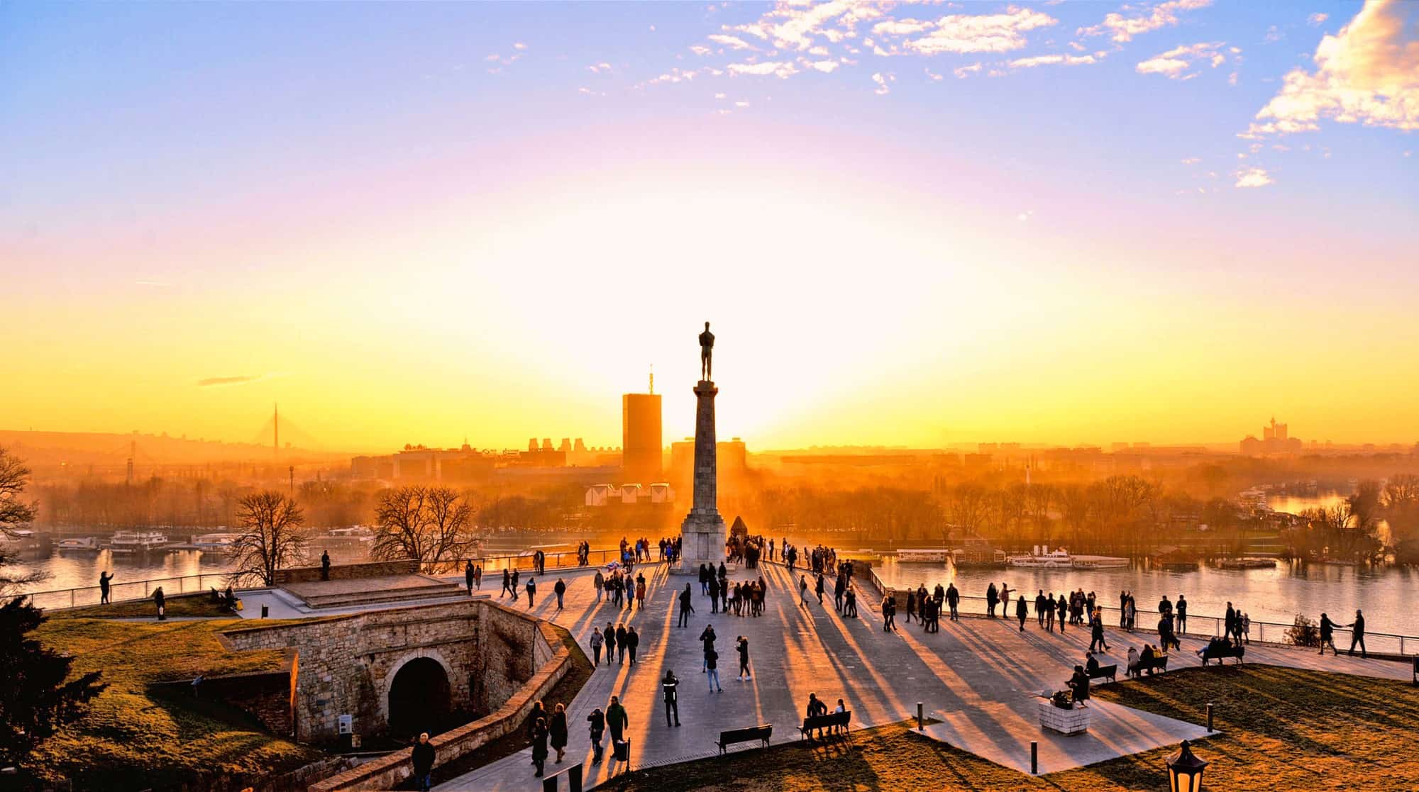 Statue and silhouettes of people at Fortress Kalemegdan in Belgrade, Serbia at sunset
