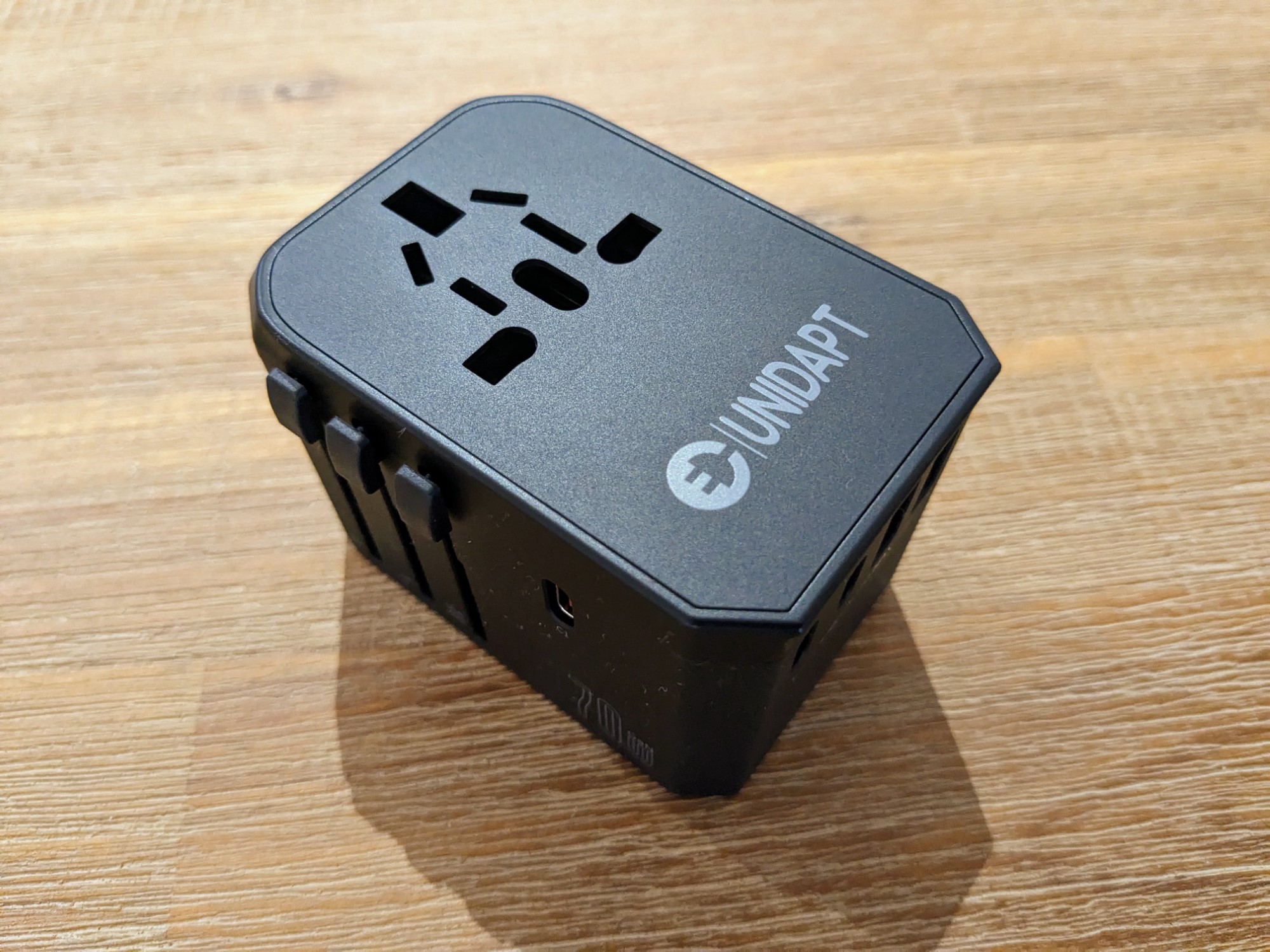 Unidapt 70W travel adapter on wooden table