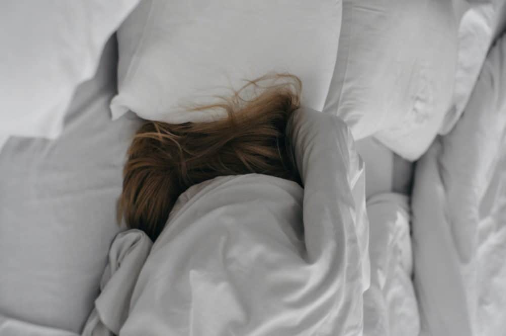 Woman in bed trying to sleep