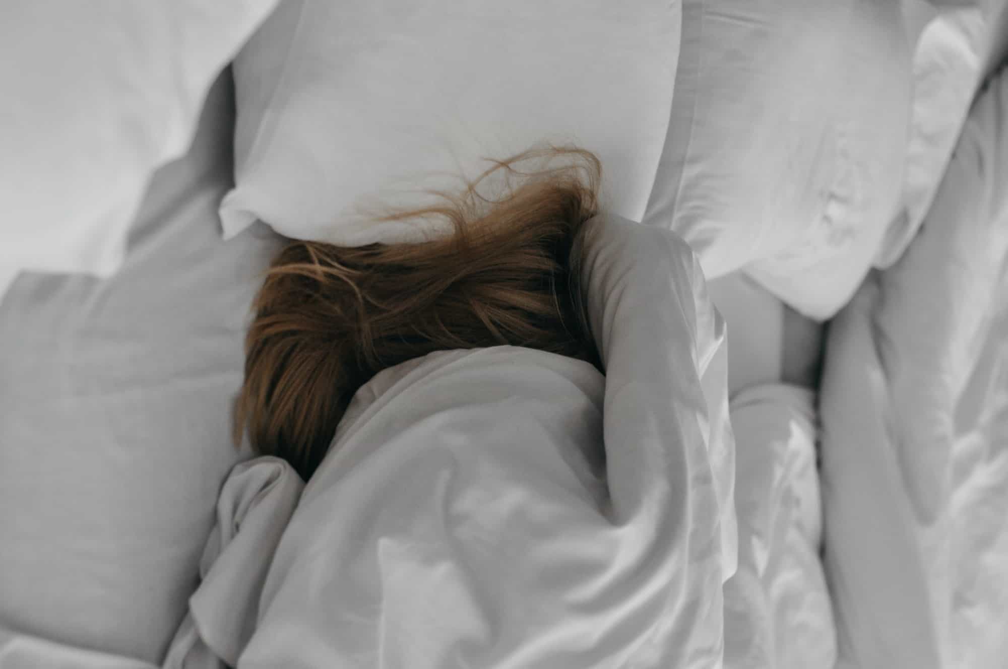 Woman in bed trying to sleep